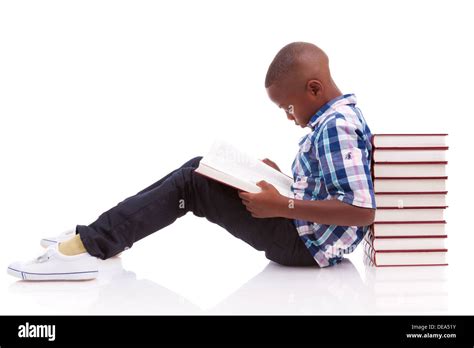 African American School Boy Reading A Book Isolated On White