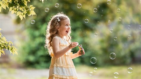 Smiling Little Girl Child Is Playing With Bubbles Hd Cute Wallpapers Hd Wallpapers Id 54738