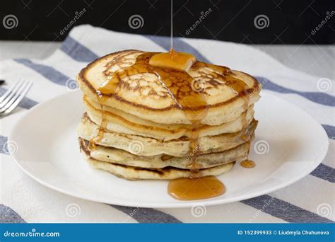 Homemade Pancakes With Butter And Maple Syrup On A White Plate Side