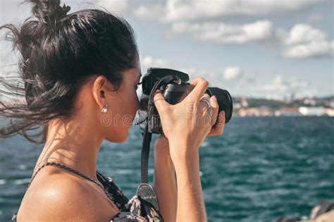 Female Photographer Taking Pictures Of Mountain Landscape At Sunset