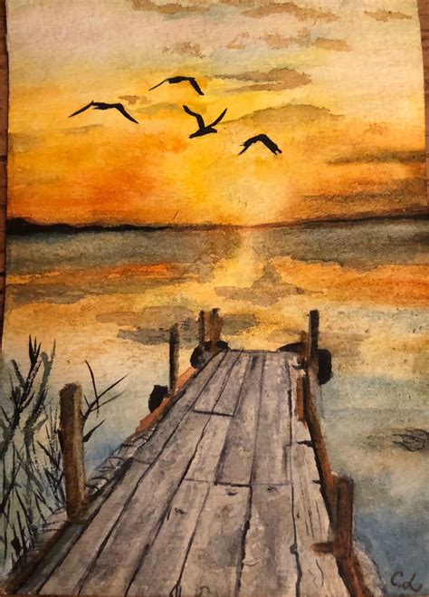 The Old Dock Ends At Natures Wonderous Sunset Over The Still Waters