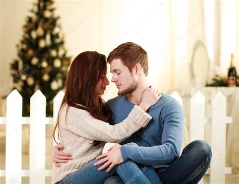 Couple In Love Embrace Each Other At Home In Festive Decorations