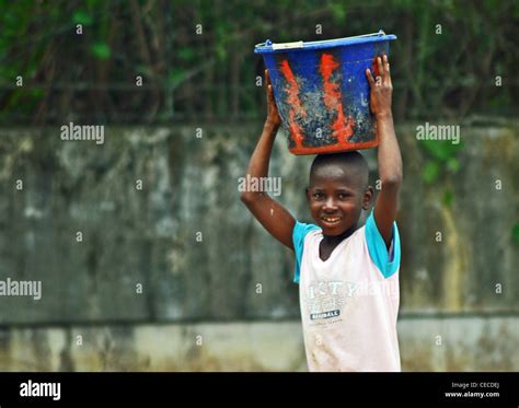 Liberian Child Carrying Bucket In Kolahun Liberia Stock Photo Alamy