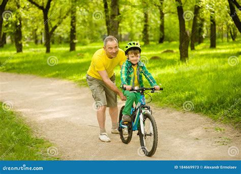 Father Teaches His Son To Ride A Bike Stock Image Image Of Healthy