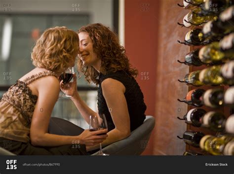 Lesbian Couple Drinking Wine Together And Kissing Stock Photo OFFSET
