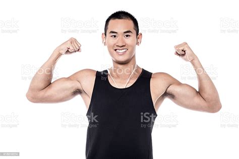 Muscular Man Flexing His Biceps Stock Photo Download Image Now