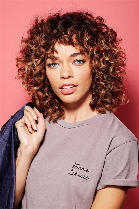 Accessorize this hairstyle with a pair of rounded glasses. Flaunt Your Curls with These 20 Curly Hairstyles with Bangs