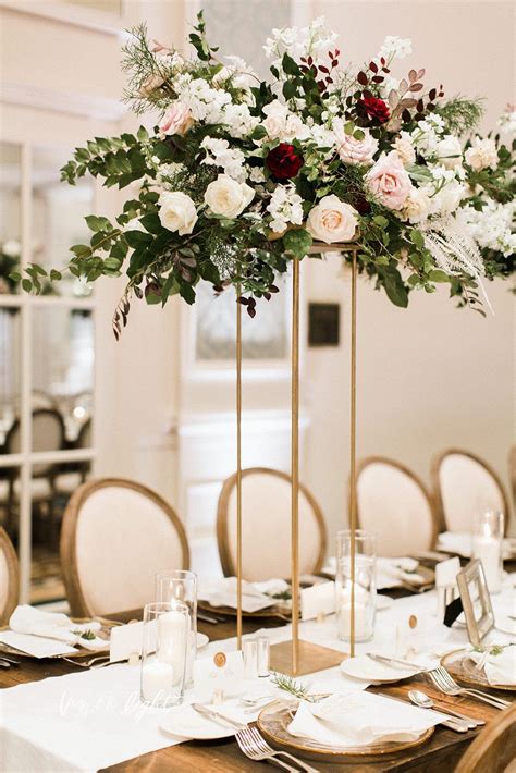 Tall Winter Arrangement Of White Roses Blush Roses Plum Branches