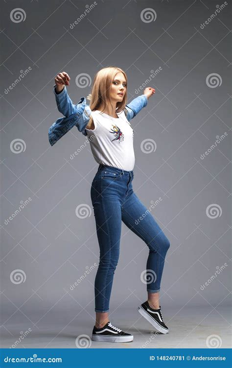 Beautiful Blonde Woman Dressed In A Denim Jacket And Blue Jeans Stock Image Image Of Legs