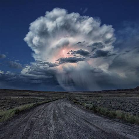 A Massive Cumulonimbus Cloud Lights Up The Sky During A Lightning Storm