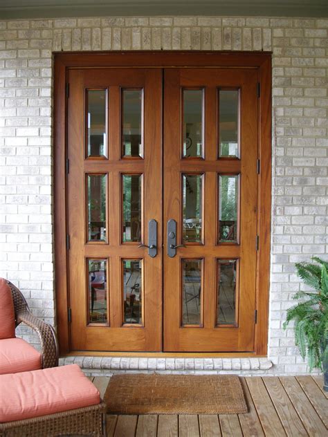 Exterior Double Brown Wooden Patio Doors With Black Metal Handles And