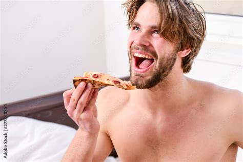 Cropped Image Of Shirtless Sexy Man With Pizza On Bed Man Bearded