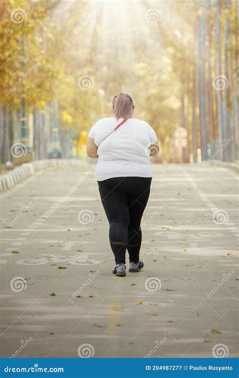Rear View Of Young Fat Woman Walking On The Road Stock Image Image Of