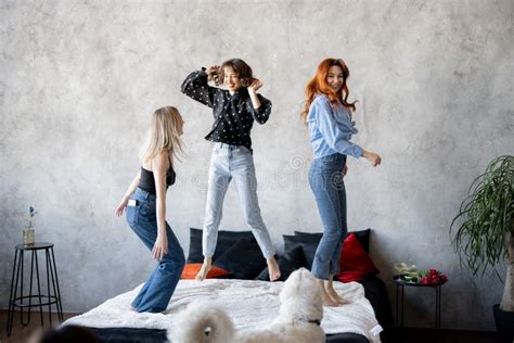 Adult Girlfriends Having Fun Jumping Together On Bed At Home Stock Image Image Of Cheerful
