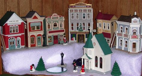 A Group Of Toy Buildings Sitting On Top Of A Snow Covered Ground In