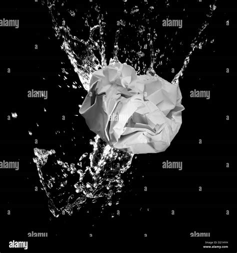 Crumpled Paper Ball Splashing Into Water Close Up Stock Photo Alamy