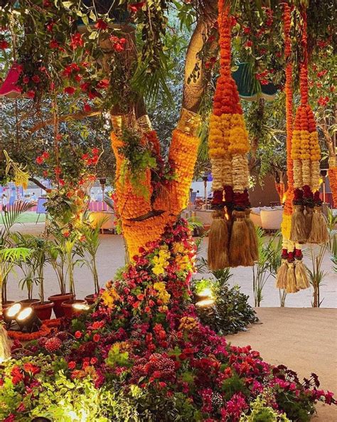 An Arrangement Of Flowers And Plants Hanging From The Ceiling In Front