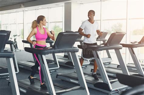 Man And Woman Couple In Gym On Treadmills Stock Photo Image Of