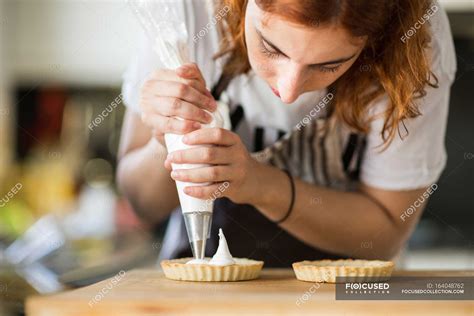 Woman Putting Cream On Tarts — Preparing Delicious Stock Photo