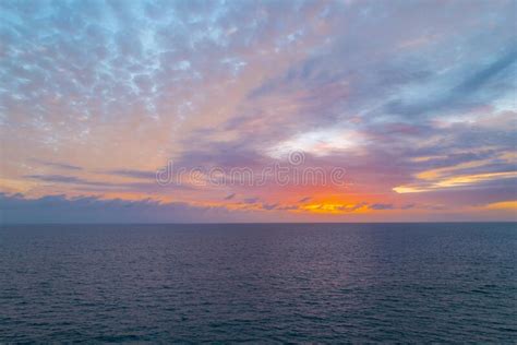 Ocean Sunset On Sky Background With Colorful Clouds Calm Sea With