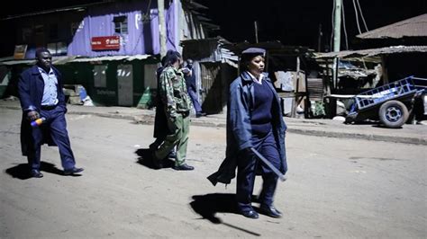 Kenyan police hold back ferry passengers causing a crowd to form outside the ferry in mombasa, kenya on friday, march 27, 2020. Fury in Kenya over police brutality amid coronavirus curfew - Omanghana