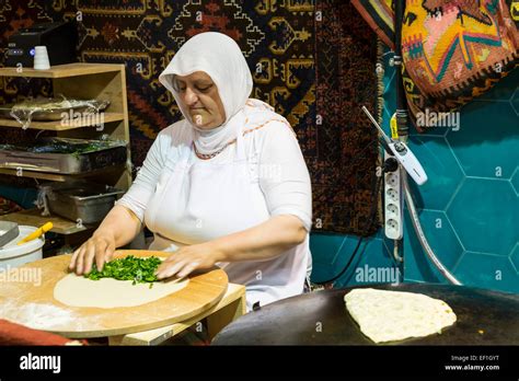 a turkish woman preparing fresh feta gozleme at a street restaurant in sultanahmet istanbul