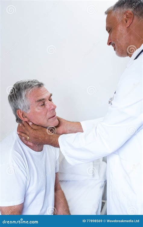 Male Doctor Examining Senior Mans Neck Stock Image Image Of