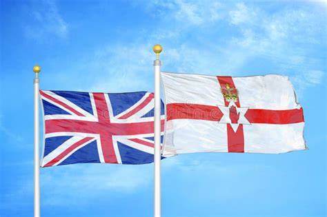 United Kingdom And Northern Ireland Two Flags On Flagpoles And Blue
