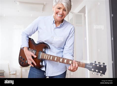 Mature Woman Playing Electric Guitar Stock Photo Alamy