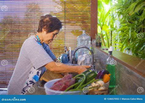 Lifestyle Portrait Of Senior Happy And Sweet Asian Japanese Retired Woman Cooking At Home