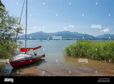 Lake Chiemsee Sailboat At The Shore With Island Herreninsel In