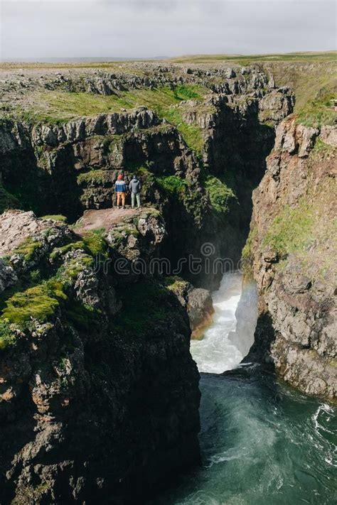 Men Stand On Edge Of Cliff At River Gorge Stock Photo Image Of