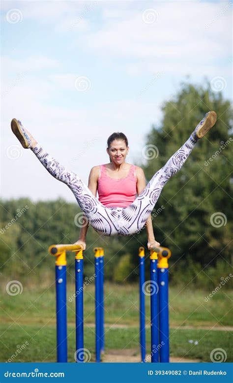 Athletic Gymnast Exercising On Parallel Bars Stock Photo Image Of