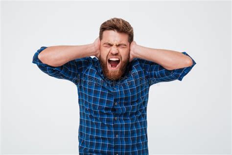 Portrait Of An Irritated Annoyed Bearded Man Covers His Ears Stock