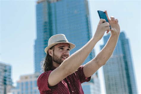 Usa New York City Man Taking A Selfie In Front Of Skyscrapers