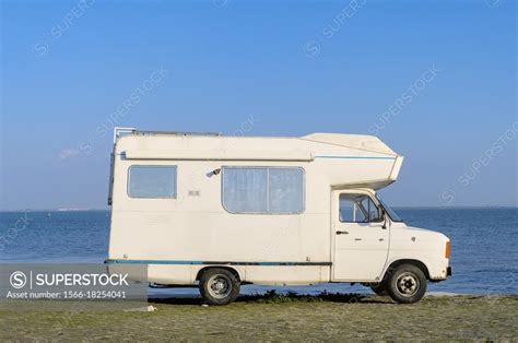 Vintage Camper Van Parked By The Riverfront Superstock