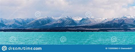 Distinctive Blue Water Lake With Snow Capped Mountain Alps In