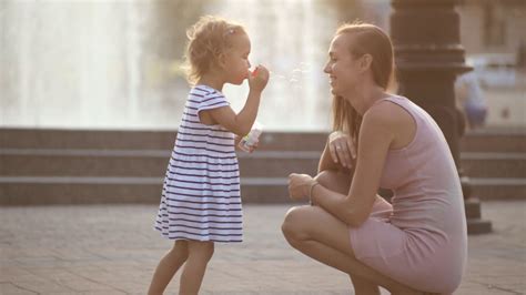 Mother Daughter Blowing Bubbles In Park Stock Footage Sbv 308882842
