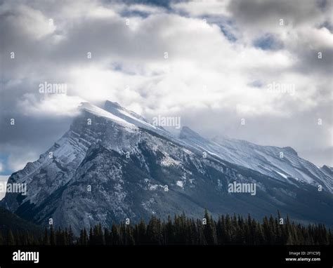 Snowy Mountain Mount Rundle Covered By Snow And Shrouded By Clouds