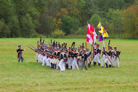 Soldiers In Historical Costumes March On The Battle Field With Flags