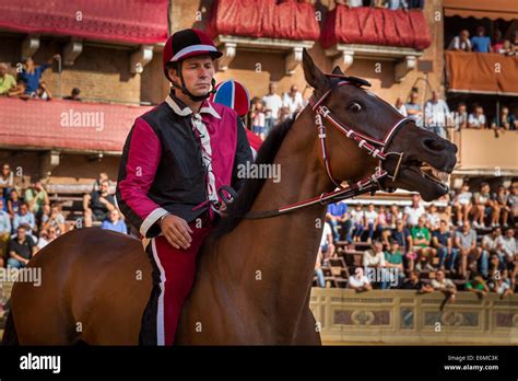 A Jockey Waiting For The Start Of Palio Di Siena Horse Race On Piazza