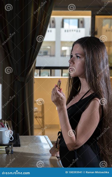 Beautiful Girl Paints Lips In Front Of A Mirror Stock Image Image Of Clothing Happy 100393941