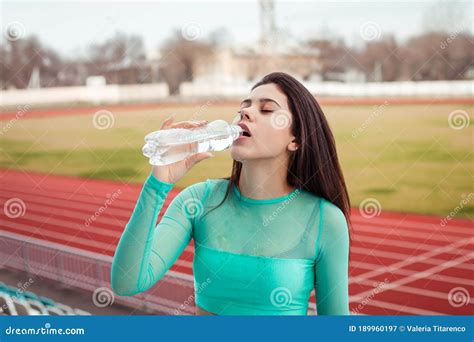 Beautiful Girl Drinks Water From A Bottle After Sports Training Stock