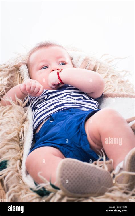 Adorable Baby Boy Lying In Bed Over White Background Stock Photo Alamy
