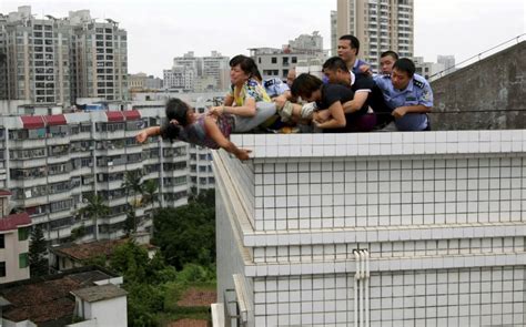 Woman Rescued During Suicide Attempt From Roof In China