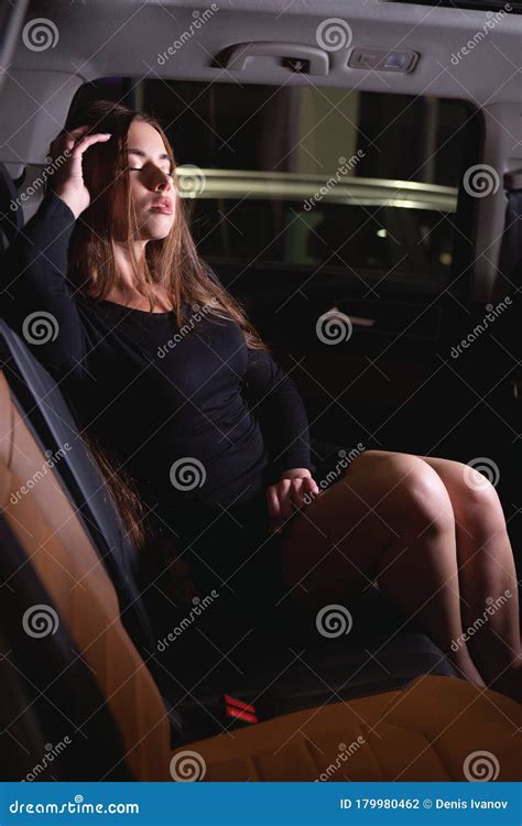 Girl In The Back Seat Of The Salon Of An Expensive Car Straightens Her