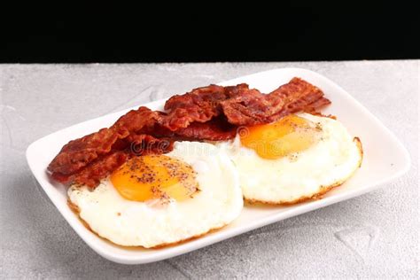 Fried Egg With Bacon On Plate Breakfast Concept Close Up Stock Photo
