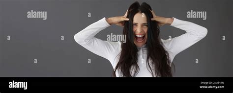 Beautiful Brunette Woman Yells Holding Her Head Stock Photo Alamy