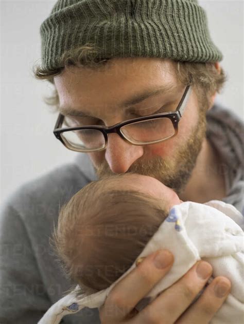 Father Kissing His Newborn Girl Stock Photo