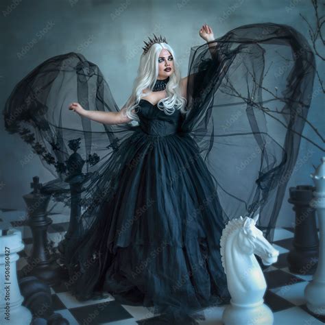 A Gothic Beauty A Dark Evil Queen In A Black Fluffy Dress With Chess